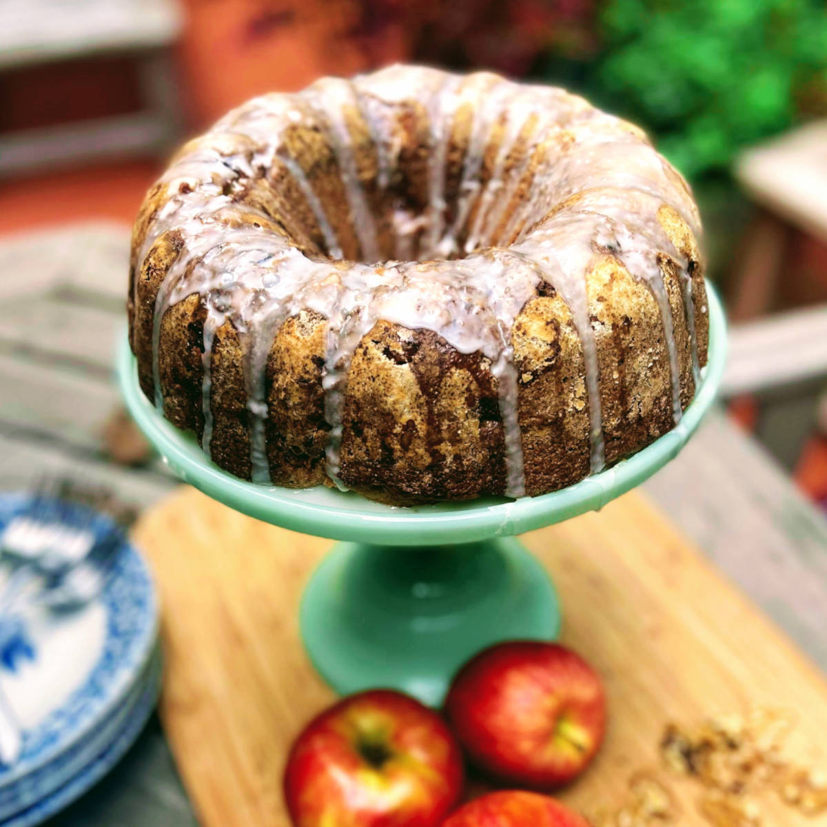 glazed apple walnut bundt cake on cake stand